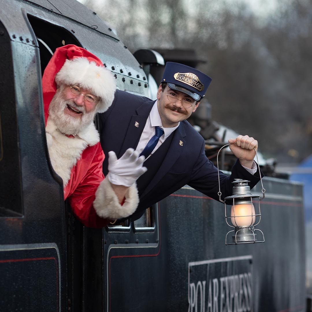 conductor and santa on board the polar express train ride