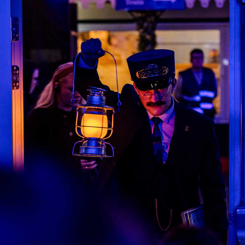 conductor with lantern at the polar express train ride